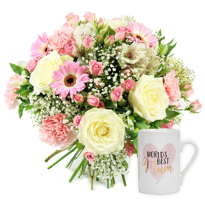 Photographed against a flawless white background, this image showcases a loving floral and keepsake mug set that feels perfect for a Mill Hill celebration. On the left, occupying most of the frame, is a lush, domed bouquet, arranged in a hand-tied style with stems gathered tidily at the base and slightly fanned out. The colour palette is soft and comforting: large cream or pale yellow roses sit at the heart of the design, their spiralling petals generously open, while blush-pink carnations with scalloped, ruffled edges add depth and a sense of movement. Nestled around them are smaller clusters of darker pink spray roses, some still in bud, creating points of contrast and suggesting longevity. Bright pink gerbera daisies, their petals radiating around dark brown centres, bring a cheerful, daisy-like character that naturally draws the eye. These are interwoven with slim, fluted white alstroemeria, each petal faintly marked with reddish-brown speckles, which add elegance and a slightly wilder, garden-inspired line to the arrangement. Fine sprays of white gypsophila weave among the larger blooms like a delicate mist, softening the boundaries and providing a romantic, airy texture. Subtle touches of green foliage break through, echoing the tree-lined avenues and open green spaces around Mill Hill. To the right of the bouquet, a pristine white ceramic mug stands upright, its glossy finish and rounded handle clearly defined. The mug is decorated with a soft pink, watercolour-style heart framing the words WORLD'S BEST Mum, with the first part in crisp black lettering and Mum rendered in a shimmering gold or rose-gold script that catches the light. The evenly lit, shadow-free composition conveys a sense of calm appreciation and heartfelt thanks, ideal for Mother's Day, birthdays, or spontaneous gestures, and could easily be imagined as a same-day delivery from Flowers Mill Hill to a cherished North London mum.