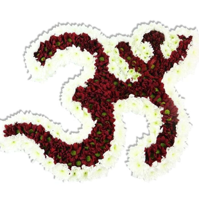 A beautifully composed floral Om symbol floats against an immaculate white background, an object of calm geometry and careful horticultural technique. The symbol's form-the familiar three-part curve, the descending stroke and the crescent with its dot-is constructed in a dense field of dark red to maroon chrysanthemums, each tiny bloom packed shoulder to shoulder so the surface appears plush and velvety. Many of those red heads reveal a lime-green centre, a small, livelier note that breaks up the deep tone and adds texture to the visual mass. Encircling and defining the icon is a thick, even border of delicate white spray chrysanthemums that carve out the negative spaces and heighten the symbol's readability; this white ribbon of flowers gives the piece luminosity and a gentle halo effect. The lighting is soft and neutral, accentuating the plush petal texture and producing a soft drop shadow beneath the arrangement that gives it subtle depth and presence. The scent is low and earthy, a clean, botanical hush rather than an overpowering perfume, suggesting suitability for quiet devotional settings. As crafted by Flowers Mill Hill for local ceremonies around Mill Hill Park, Mill Hill Broadway or on Rowley Lane, the tribute feels both personal and ceremonial-purposeful for a memorial, respectful for a temple offering, or meditative as a centrepiece at a yoga event. The workmanship is evident in the tight packing of blooms and the precise white outline, creating an image that communicates devotion, serenity and a skilled florist's attention to sacred form.