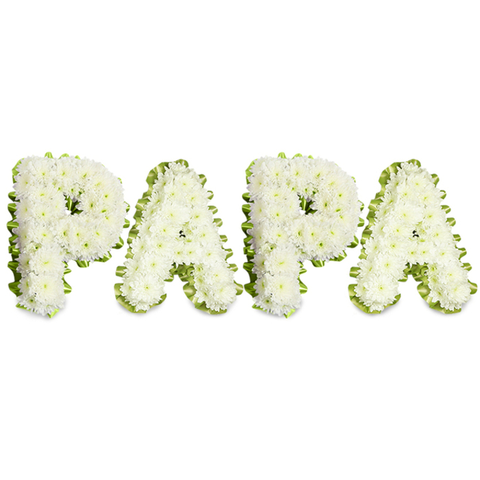 A lovingly made funeral tribute that spells PAPA in bold, uppercase letters, each letter densely packed with small, snowy-white chrysanthemum blooms that form a soft, textured surface with a slightly rounded profile. The composition is deliberately restrained: a narrow, pale green ribbon or trim of fresh foliage outlines each character, the ribbon's subtle waves and tiny pleats giving the letters a refined edge that reads clearly from a short distance. The white flowers glow against a clean white background, lending the piece a serene luminosity that suits wakes, memorial services, or graveside remembrances for a beloved father or grandfather. From the florist's vantage this is a classic sympathy design - careful flower selection for longevity, compact wiring to hold the clusters, and a uniform density across all four letters so the name sits evenly on a horizontal plane. There is a soft floral note in the air, scarcely intrusive, and the green edging brings a hint of renewal to the somber palette. Locally in Mill Hill this style is often chosen by families seeking a personal, recognizable tribute at St Paul's Church or for services near The Ridgeway, where simple, heartfelt designs help frame photographs and memorial candles. The arrangement reads as both a clear, personal message and an emblem of quiet respect, conveying purity, memory, and enduring affection.