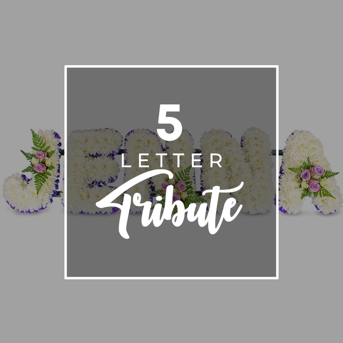 A dignified five-letter funeral tribute is the subject of this photograph, laid out in a neat line on a flat, light grey background that gives the image a clean, contemporary feel while keeping the focus on the flowers. Each large letter is built from a base of firm white chrysanthemums, densely clustered so that the blossoms touch, creating a softly textured surface reminiscent of a padded quilt. Along the edges, a band of deep purple satin ribbon has been carefully applied, following every curve and corner with precision, and adding a rich, jewel-like frame that enhances the clarity of the letter shapes. Here and there along the tribute, the white expanse is gently interrupted by small, artfully positioned groups of accent flowers. These consist of delicate pale pink and mauve spray roses interlaced with fine green fern fronds and sprigs of fresh foliage, adding subtle hints of colour and a sense of living movement. In the centre of the composition, a square overlay in a slightly darker shade of grey is bordered by a slim white frame. On this overlay, crisp white text reads 5 LETTER in an understated sans-serif font, with the word Tribute beneath in a more flowing, calligraphic style. The overlay sits over part of the floral letters, which appear to spell JOHN A, hinting at the customisable nature of the tribute. The arrangement feels appropriate for a thoughtful farewell at a church or crematorium in Mill Hill, perhaps close to the green spaces that define the area. It suggests that each letter has been created with care and intention, offering families a way to see a beloved name or word captured in soft white petals and respectful purple accents.