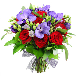 From the worktable of Flowers Mill Hill, this bouquet is a vivid dialogue between boldness and tenderness. The plush crimson roses provide a romantic heartbeat while the royal purple Vanda orchids unfold like wings, their broad petals speckled with lilac shadows for an exotic shimmer. Nestled among them, creamy lisianthus crowns and closed buds hint at new beginnings and shared celebrations. A veil of deep green foliage-large, glossy leaves and wispy sprigs-wraps the arrangement in a secret garden, giving it fullness and movement. The composition culminates in a dark, open-weave mesh ribbon at the base, a modern contrast to the soft curves of the blooms. It feels both dramatic and intimate, ideal as a dramatic romantic gift, an impressive table centerpiece for an anniversary dinner, or a lavish thank-you gesture. The bouquet is crafted to travel well, with sturdy stems and careful wiring so it remains pristine from Mill Hill Broadway to nearby Finchley and beyond. Delivery is available across Mill Hill and the surrounding neighbourhoods, and this piece showcases our commitment to freshness, artistry, and thoughtful detail, from the choice of blooms to the precise balance of colour and texture.