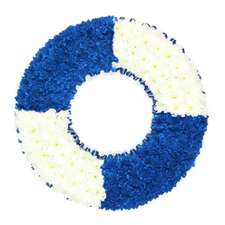 This image shows a beautifully composed circular flower wreath, deliberately styled to resemble a classic maritime lifebuoy, resting against a bright white background that lets the colours and textures truly stand out. The ring is flawlessly round and generously covered with hundreds of small, daisy-like blossoms, each bloom pressed closely to the next, giving the arrangement a smooth, continuous surface that feels both lush and softly tactile. The design is divided into four equal segments, alternating between royal blue and clean white, echoing the familiar pattern of a safety ring. The top-left and bottom-right quadrants are filled with deep blue flowers, their petals forming a rich, velvety field that suggests depth and steadiness; opposite them, the top-right and bottom-left segments are composed of pure white blooms, offering a cool, serene lightness. Together, these colours recall the uniforms and insignia often associated with naval service and maritime life, themes that resonate for families in Mill Hill who may be remembering a relative with seafaring ties or a lifelong love of the coast. Around the inner rim of the wreath, a narrow dark blue ribbon has been neatly pleated into gentle ruffles, creating a refined frame that accentuates the central opening and enhances the lifebuoy silhouette. The arrangement exudes a sense of order, respect, and quiet strength, its careful symmetry and crisp colour blocks making it particularly suitable for a formal funeral or memorial service. Crafted with the sensitivity of an experienced local florist, it feels like a floral 'lifeline'-a visual expression of gratitude for the protection, comfort, or guidance a loved one offered, now translated into a final, dignified tribute.