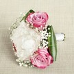 Crafted with an artistry that reflects the serene charm of Mill Hill, this romantic hand-tied bouquet lies gracefully atop a lightly textured, natural-hued fabric. Three vibrant pink roses captivate, their petals layered in lively gradations from bold fuchsia at the edges to gentle blush and soft lavender at the coiled centers-an effortless symbol of love and new beginnings shared in Mill Hill's leafy neighbourhoods. At the heart, a lavish white peony unfurls its satin-soft, ruffled petals, emanating a freshness and fullness reminiscent of gentle spring mornings in NW7 gardens. Delicate sprigs of baby's breath trace through the floral ensemble, offering a whimsical scattering of tiny white blooms that lend a dreamy, cloudlike texture. Lush emerald green leaves cradle the bouquet, their verdant sheen framing the delicate blossoms, while a smooth white satin ribbon securely wraps the stems, its streamlined finish hinting at the expertise behind every detail. Set against a neutral linen-like backdrop, each flower's colour and curve are illuminated by soft, even lighting. Ideal for a bridesmaid's arrangement or to mark a cherished occasion along Daws Lane or The Ridgeway, this bouquet embodies elegance, artistry, and the quiet joy of heartfelt celebration in Mill Hill.
