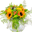 There's an unmistakable sense of joy in this bouquet, reminiscent of Mill Hill's sunny open commons and tree-lined lanes. Two large sunflowers form the display's focal point, each boasting a golden corona and deep cocoa center, radiating the confidence and optimism of a cloudless summer's day. Surrounding them, dainty yellow filler flowers-possibly solidago-contribute texture and an additional layer of sunny brilliance. Coral-orange blooms subtly peek from the heart of the arrangement, hinting at joyful spontaneity and the spirit of lively Mill Hill gatherings. The greens are as abundant and fresh as local hedgerows, with feathery ferns arching gracefully outward like lace, mingling with silvery eucalyptus and zesty lime-toned sprigs for a refreshing, contemporary twist. Set within a spherical glass vase filled with clear water, the arrangement's stems are visible beneath the surface, highlighting the quality and care devoted to every element. Whether destined to uplift a living room near Mill Way, serve as a bright birthday surprise, or simply bring a touch of nature indoors, this bouquet-lovingly crafted by Flowers Mill Hill-promises to infuse any space with warmth, vibrancy, and the welcoming heart of the community.