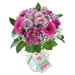 Loaded with the colour and vitality characteristic of Mill Hill, this jubilant bouquet is a visual symphony in shades of purple, pink, and white-its rounded form and lush textures ready to lift any spirit. Foremost are oversized fuchsia Gerbera daisies, their open faces and velvety black centers radiating joy and warmth. Soft lavender roses nestle beside them, their petals delicately layered as if freshly gathered from a Mill Hill garden just after sunrise. Smaller magenta chrysanthemums with intricate, plum-toned petals occupy the spaces in between, weaving in playful depth and a wild, garden-picked charm that mirrors the natural beauty along Arrandene Open Space. Scattered throughout, wispy sprigs of baby's breath add a cloud-like, ethereal touch, echoed by the shine of bold green foliage peeping out beneath. All is anchored in a clear, subtly textured glass vase, its crackled 'ice' finish catching glimmers of light, and tied with a rustic raffia ribbon. From the neck of the vase, a festive white gift tag dangles, adorned with a bright 'Happy Birthday' greeting in whimsical script and crowned by a hand-drawn pink blossom. Set against a clean, white background, the entire display reflects the blend of celebration and serenity that defines Mill Hill, making it a perfect floral gift for birthdays, anniversaries, or heartfelt thanks delivered swiftly to doors across the area.