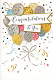 In this image, a sophisticated congratulations card stands as if ready to be placed beside a vase of fresh blooms on a windowsill overlooking Mill Hill's quiet streets. The card's design is dominated by a generous cluster of rounded balloons rising from the lower section, overlapping in a way that creates natural depth and fullness. The colours are soft yet celebratory: champagne gold and brushed silver mingle with sky blue, blush pink and gentle grey, echoing the muted elegance of an evening sky above Mill Hill. Each balloon is decorated with subtle details-slender metallic stripes, scattered star shapes or shimmering glitter-that suggest a delicate sparkle, as though catching warm indoor lighting. From the balloons' base, fine curling ribbons in gold and silver trail downward in looping spirals, giving the sense that the whole arrangement is gently lifting and swaying. Stretching across the middle of the balloons is a smooth, ribbon-like banner with gently curved ends. On it, the words Congratulations To You are written in graceful, calligraphic lettering that feels personal and warm, like a carefully chosen message for a cherished friend or family member. The background is kept understated and pale, decorated with small metallic stars, dots and swirls of confetti that drift lightly around the balloons, enhancing the celebratory mood without crowding the design. The card appears to be printed on sturdy, smooth cardstock with touches of raised glitter that would provide pleasant texture under your fingertips. Overall, it radiates joy, pride and a sense of achievement-perfect to accompany a bouquet delivered anywhere across Mill Hill when you want to mark a big step forward, whether it's a new job, exam success, or another meaningful life milestone.
