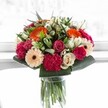 This arrangement captures a joyful moment in time, much like the inviting atmosphere found across Mill Hill's bustling neighbourhoods. Bold orange gerberas radiate welcoming warmth, blending perfectly with blushing pink roses and deeply textured magenta carnations. Creamy ivory roses and softly peach gerberas offer notes of elegance and grace, counterbalancing the more invigorating hues with a gentle tenderness. The crisp, glossy greenery wraps around the bouquet, adding depth and lushness evocative of Finchley's scattered parks and tree-lined byways. In the bright, sunlit frame, each petal's subtle details are illuminated-the delicate veins, the gradients of colour-making the whole arrangement shimmer with vitality. Ideal for marking a special milestone, brightening a loved one's day in Mill Hill, or gracing a table with a flourish of local beauty, this bouquet, created by a florist who understands the rhythm and heart of the area, is a testament to the harmony and happiness found in the world of fresh flowers.