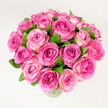A lush, hand-gathered bouquet of roughly two dozen pink roses sits in a clear glass vase, photographed against a clean, evenly lit white background. From this slight overhead, slightly elevated viewpoint the arrangement reads as an abundant, rounded dome of blooms: each rose is open or nearly open, layers of velvety petals unfurling in a subtle spiral. The colour moves across each bloom from a deep fuchsia or magenta concentrated toward the heart of some roses to softer rosy pinks and pale blush tones on the outer petals, creating a gentle gradient that gives the cluster depth and movement. Between the flowers, rich, dark green foliage peeks through-broad, glossy leaves that set the pinks off with a fresh, natural contrast and lend texture to the otherwise smooth petal planes. The clear glass vessel is faintly visible at the base, the cool transparency grounding the composition without distracting from the floral focus. Soft, diffuse daylight bathes the scene so every petal edge and subtle cream or blush highlight is discernible, while the overall impression is one of warmth and celebration. There is an unmistakable powdery, rose-sweet suggestion to the imagined scent, a delicate fragrance that echoes the visual softness. As a Mill Hill floral design, this bouquet evokes romantic occasions and heartfelt thanks-ideal for anniversaries, Mother's Day, or as a bright, cheerful centrepiece for a home near Mill Hill Broadway or Mill Hill Park. The crafted balance of colour, texture and form speaks of careful florist technique and a timeless, comforting beauty.