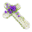 In this photograph, a floral cross created as a memorial tribute is presented on a spotless white background, giving it a pure, contemplative feel. The cross is entirely composed of white spray chrysanthemums, which have been arranged very closely together so that their petals form a smooth, plush texture across the whole design. The tiny light-green centres of the blooms are visible, adding a soft stippling of colour that enhances the sense of freshness and life. Along the outer contours, a slim lime-green ribbon or edging outlines the cross, crisply tracing the shape and providing a modern, refined finish that gently contrasts with the white flowers. At the exact centre of the cross, a lush grouping of rich purple lisianthus draws immediate attention. These blossoms, with their softly curled petals and satin-like surfaces, create a striking focal point, and their deep hue introduces a note of solemn beauty. Tucked among them are slender sprays of foliage, a few small filler stems, and purple buds in various stages of opening, which add natural variation and texture. Some of these lisianthus blooms and buds trail lightly along the lower right arm of the cross in a subtle cascade, suggesting movement while remaining harmonious with the overall design. The lighting is bright yet gentle, producing a delicate shadow below the cross, which helps define its contours and depth, almost as if it rests on a table in a quiet Mill Hill florist's studio. The composition conveys calm, reverence, and remembrance, suitable for a funeral service around Mill Hill Broadway or a private farewell at a nearby cemetery, offering comfort through its blend of white purity and purple grace.