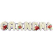 This image shows an elegant floral tribute spelling GRANDMA in large, block letters, a design often chosen by families in Mill Hill who want a distinctly personal farewell at a funeral or cremation service. Each letter is completely covered in pristine white cushion chrysanthemums or similar delicate florets, packed closely together so that their tiny petals form a soft, plush surface, like a series of white cushions arranged in a row. Around the outer edge, a fine border of pale purple ribbon or backing offers a gentle contrast, outlining the letters with a subtle, lavender-toned frame that stands out lightly against the plain white background. Carefully placed red flower groupings bring warmth and emotion to the arrangement. On the initial G, a small but striking collection of deep red roses sits alongside a red-and-white variegated calla lily, its curved, trumpet-shaped bloom introducing fluid lines amidst the rounded chrysanthemums. The first A is marked by a single, heart-shaped red anthurium at its base, its glossy, almost porcelain-like petal catching the light. At the centre of the word, the M carries another cluster of crimson roses and a matching red anthurium, drawing the eye to the heart of the tribute, while the final A echoes this sentiment with one last red anthurium flower. A dark green frame supports the letters discreetly from behind, keeping them aligned when displayed at a Mill Hill chapel or graveside near Mill Hill Broadway. The overall feeling is one of serenity and devotion, a floral testament to a grandmother's enduring place in the family's heart.