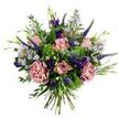 This hand-tied bouquet reads like a gentle dawn in a Mill Hill garden: soft antique-pink roses-some in tight buds, others unfurling with slightly darker pink petal edges-form the tender centre, cushioned by two full, dusty-rose carnations whose ruffled layers add warm, velvety texture. Tall, indigo-violet spikes of veronica lift the eye with elegant vertical lines while clouds of pale lavender-blue aster-like blooms, each with tiny yellow centres, breathe an airy, meadow-like quality through the composition. Deep purple lisianthus (eustoma) buds and small open blooms punctuate the palette with jewel-toned accents, and slender green leaves and emerging buds weave through the flowers to keep the arrangement feeling wild yet composed. The greenery base is a thoughtful mix: rounded, silvery eucalyptus leaves lend soft, muted contrast and a faint, fresh scent, while lime-green, bushy filler-reminiscent of Santini chrysanthemums or viburnum-adds sprightly texture and brightness. Stems are gathered and visible at the base, unmistakably hand-tied, giving the bouquet a relaxed, artisanal silhouette that suggests it was gathered from a lush allotment behind a Mill Hill terrace. Soft natural light warms the petals, hinting at a subtle garden fragrance of green leaves and dewy blooms. Suited to birthday surprises, heartfelt thank-you gestures, or to lift a sitting room near Mill Hill Park, this arrangement balances refinement and rustic charm while reflecting the quiet, leafy character of the neighbourhood.