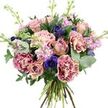 A richly textured, rounded bouquet is photographed in crisp detail against a plain white background, turning the flowers into the sole focus of the scene. At its heart are roses in gentle shades of dusty pink and muted peach, their petals unfurling in layered spirals that range from tight, promising buds to open blooms showcasing their full, velvety interiors. Embracing these central roses, plush carnations provide both volume and intricate texture, their ruffled petals traced in vivid magenta along the edges and softening into a warm blush tone towards the centre, creating an elegant ombré effect. Nestled among these romantic tones, deep indigo and violet-blue anemones punctuate the bouquet, their dark, nearly black centres offering bold contrast and a sense of depth. Rising through the arrangement, slender stems of lavender and pale pink stock carry rows of clustered florets, adding a delicate, feathery vertical dimension that softens the overall silhouette. The flowers are surrounded by layers of greenery: cool, rounded eucalyptus leaves in silvery green intermingle with darker, broader leaves, forming a lush, natural frame that suggests both structure and gentle movement, like a garden breeze in one of Mill Hill's leafy back gardens. At the base, the stems are neatly hand-tied, with their fresh green and woody textures clearly visible, underscoring the careful work of a skilled local florist at Flowers Mill Hill. Bright, even lighting illuminates each bloom, capturing subtle colour gradations and fine details without harsh shadows. The bouquet conveys a mood of quiet celebration and thoughtful care, easy to imagine being delivered to a home near Mill Hill Broadway, a café by the station, or a family gathering up on the Ridgeway, marking birthdays, anniversaries, or simply brightening an ordinary day.