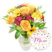A bright, celebratory gift pairing captured against a clean white backdrop: a lush, hand-arranged bouquet set in a clear glass vase sits slightly left of centre while a glossy round foil balloon nestles to the lower right, lightly overlapping the vase. The flowers read as a warm, sunlit tapestry - several full, peachy-orange roses with soft, spiralling petals form the focal point, their velvety texture catching a gentle, diffused light. Sunny yellow gerbera daisies, with their flat, cheerful faces and dark brown centres, punctuate the composition like little suns. Deep burgundy carnations, densely ruffled and richly shaded, create plush contrast and depth, while delicate white alstroemeria (Peruvian lilies) with narrow speckled petals breathe an airy elegance through the arrangement. A generous cloud of glossy green foliage - broad leaves and fine textured sprigs - frames and lifts the blooms, the stems crisply visible through the transparent water in the vase to suggest freshness and recent care. The round white balloon is playfully decorated with scattered gold and fuchsia polka dots and tiny heart motifs; in the centre a flowing pink script proclaims Best Mum, turning the whole image into a tender message of gratitude. The overall mood is one of bright affection and thoughtful celebration: a bouquet that would bring a soft citrus-rose scent and instant cheer to a Mill Hill kitchen table or bedside, equally suited for a Mother's Day surprise, birthday greeting, or simple thank-you to a cherished mum in the local community.