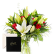 Like a modern still life, this bouquet pairs the refined purity of white lilies with the passionate heat of classic red roses. Each lily, some delicately opening while others remain in poised bud, sends out a gentle, sweet scent-a whisper of fresh spring mornings. The roses, velvety and rich, nestle comfortably among lush, vivid green foliage, their fiery presence radiating admiration and strength. Eucalyptus sprigs and wispy grasses add movement and a subtle, herbal freshness, while a light falls softly over the petals, highlighting the crisp contrast of colour and the decadent texture of each bloom. 

Designed with gratitude and reverence, this arrangement feels like an ode to someone cherished and extraordinary-a vibrant tribute for a milestone, a heartfelt thanks, or simply to celebrate a personal hero. The bouquet rests in a clear glass vase, its stems neatly bound, and the whole piece wrapped with care for delivery across Mill Hill and nearby areas. Flowers Mill Hill understands the art of balance; the perfume lingers gently, never overpowering, a thoughtful gesture from our local team to brighten a home, a hospital ward, or a workplace in Mill Hill.